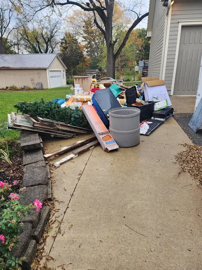 Dumpster being loaded with debris for Residential Dumpster Rental in Pine Island